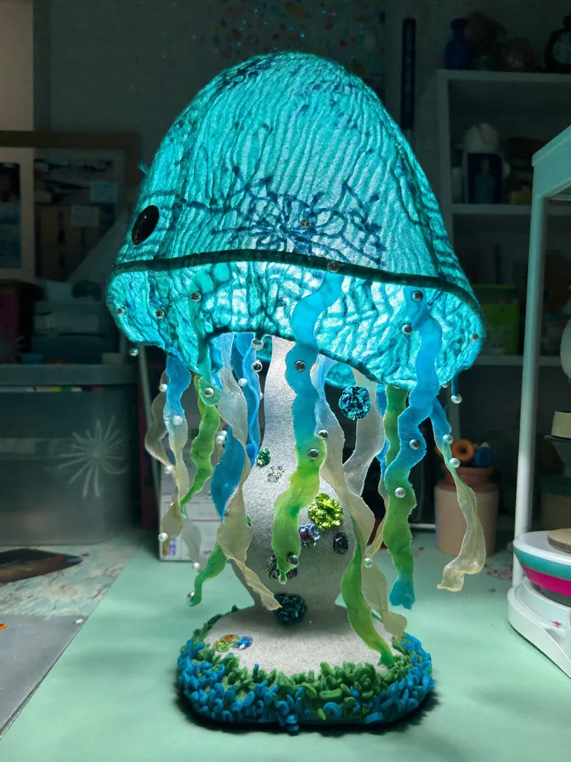 A straight-on medium shot captures a handmade jellyfish-shap…